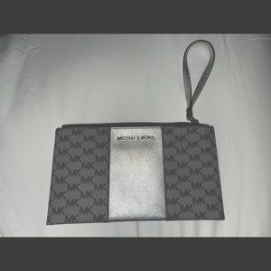 MK silver black and grey clutch in new condition.